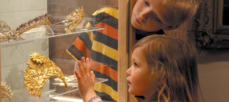 A little girl admiring the tiaras in the Corinium Museum in Cirencester