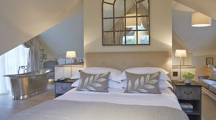 Bedroom with feature bath at Dormy House Hotel