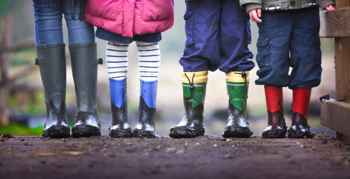 Children standing in a line with muddy boots