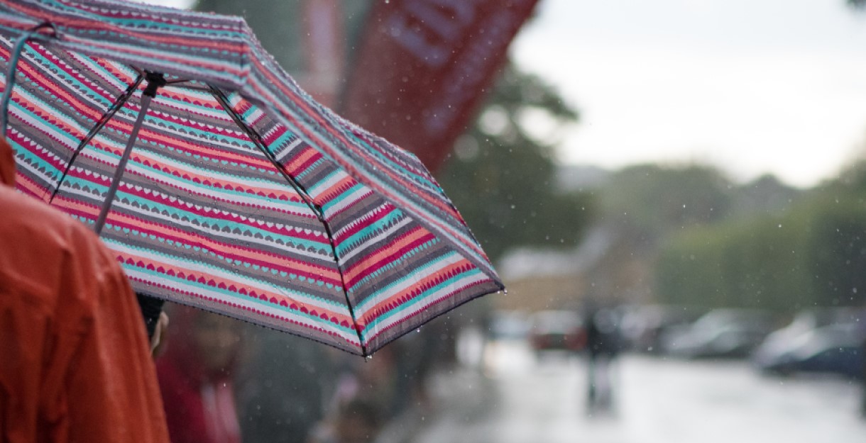Someone holding an umbrella on a rainy day