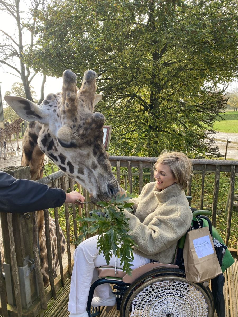 Heidi Herkes feeding a giraffe at Cotswolds Wildlife Park