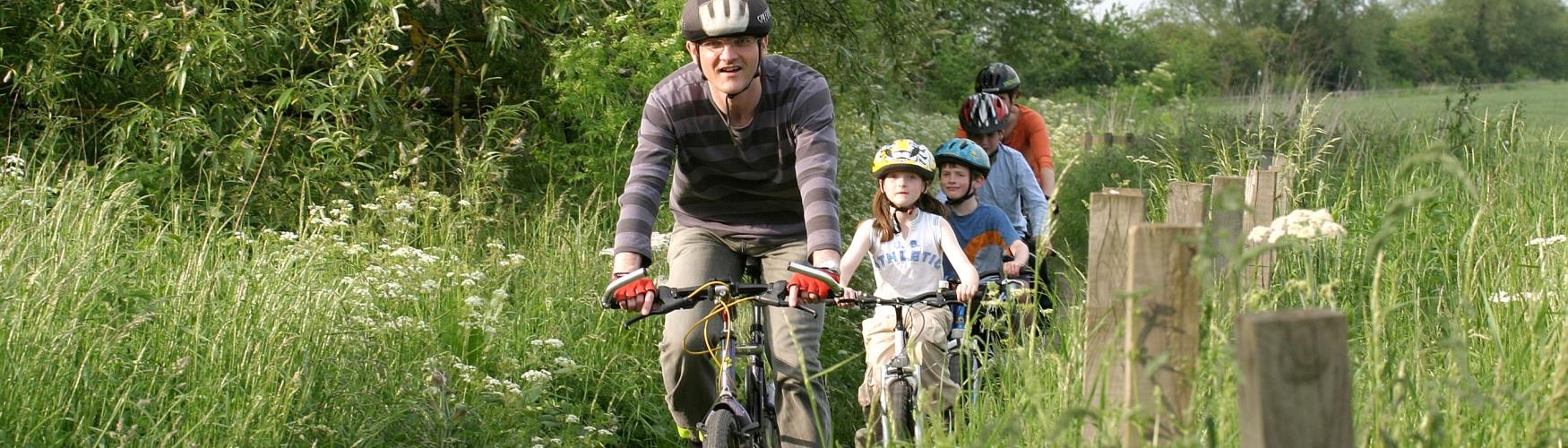 A family cycling in the countryside