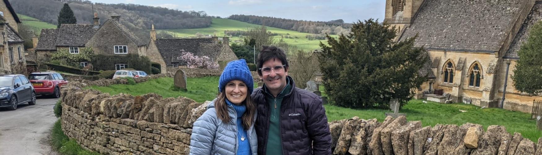 Couple in a quintessential Cotswold village with Cotswold Tours & Travel