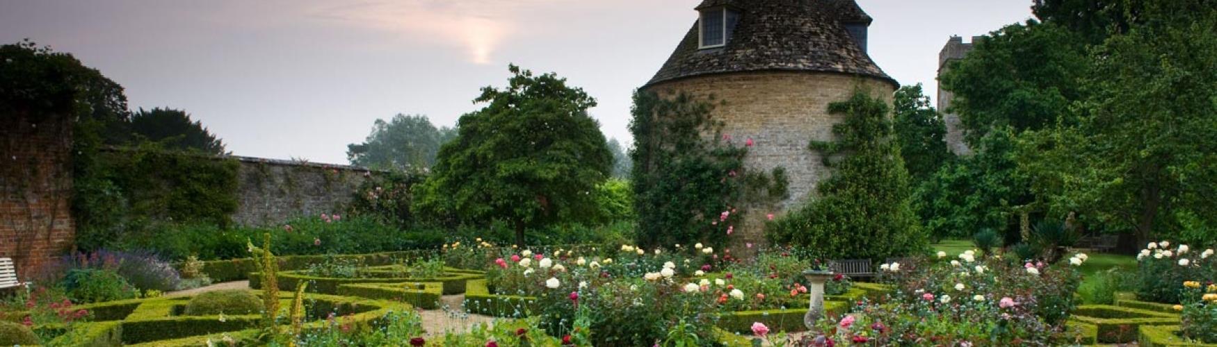 The dovecote surrounded by roses at Rousham (photo Harpur Garden Images)
